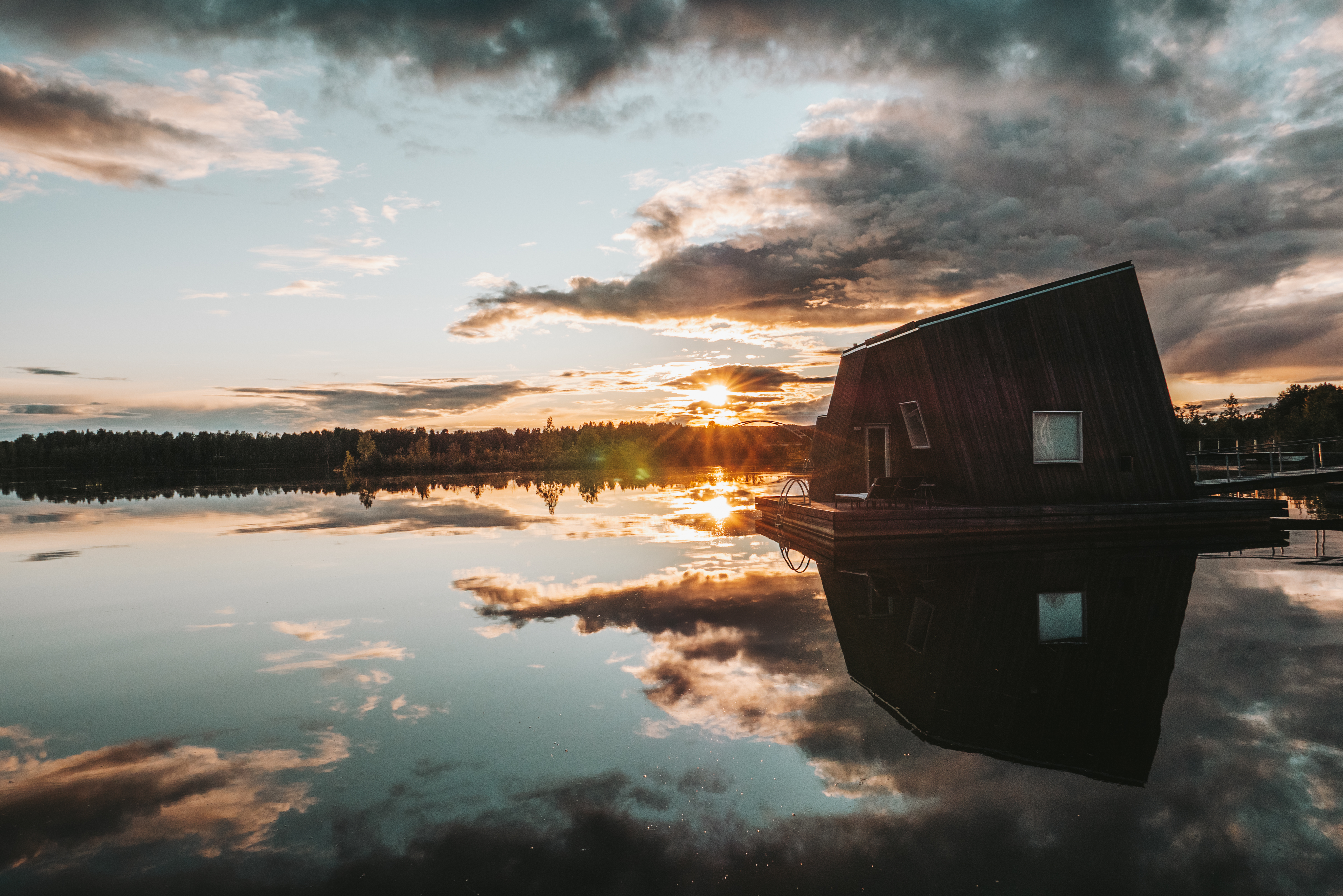 A floating Water Cabin on the river at Arctic Bath in low evening light.