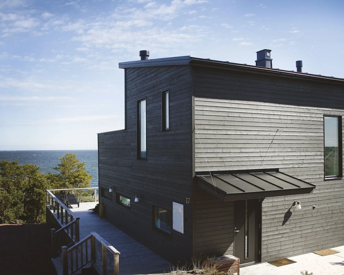 Timber house number 17 at HavsVidden, with a terrace and sea views.