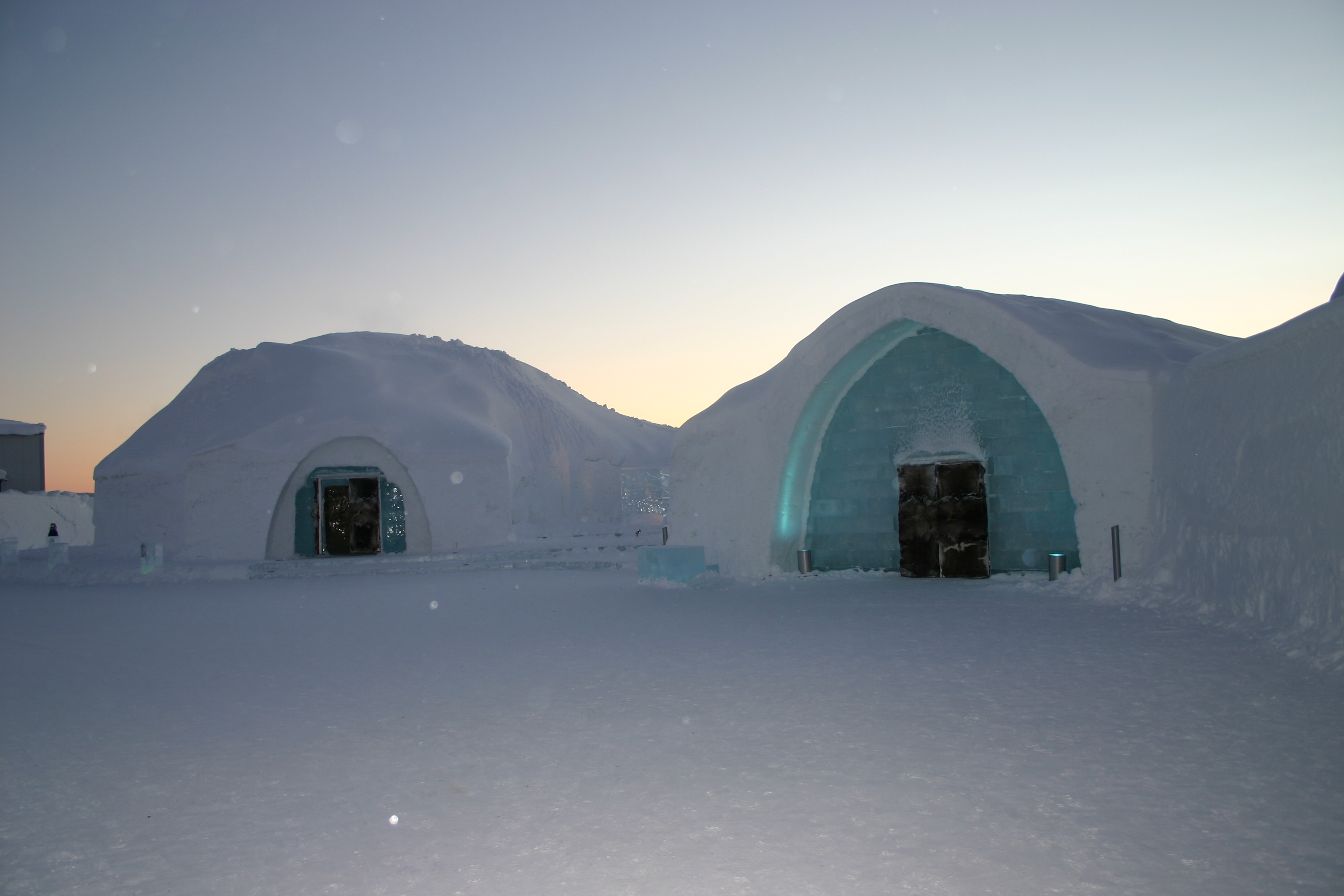 Snow and ice entrances at Icehotel in low winter light.