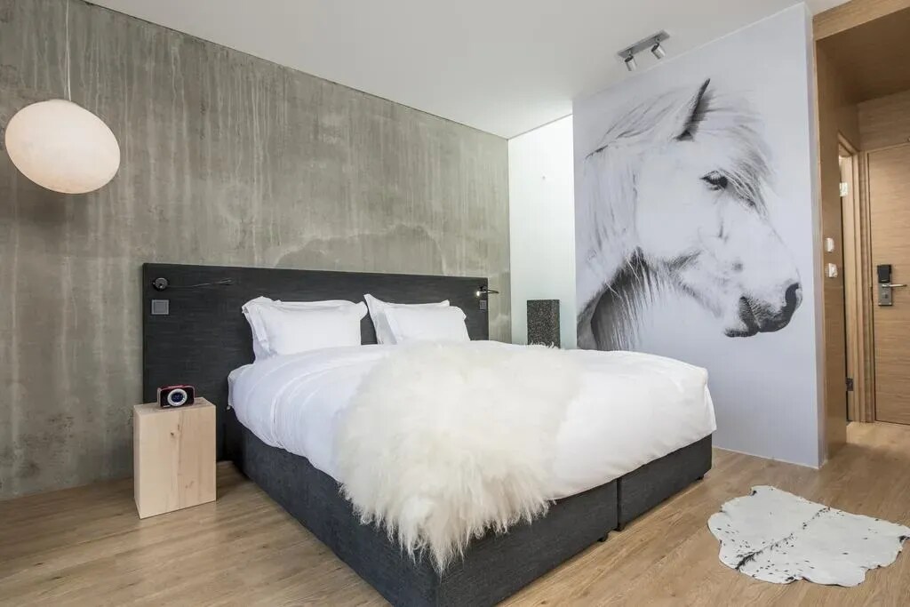 Guest room with a horse mural at ION Adventure Hotel