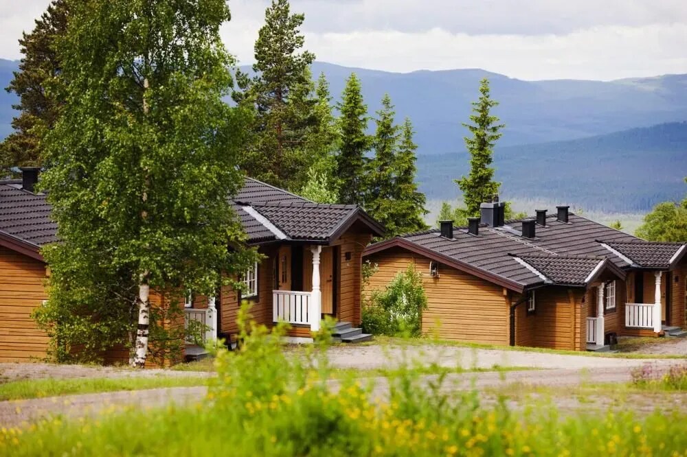 Wooden cabins among trees at Långberget