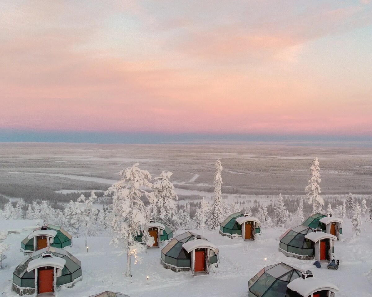 Glass igloos on a snowy hillside at Levin Iglut