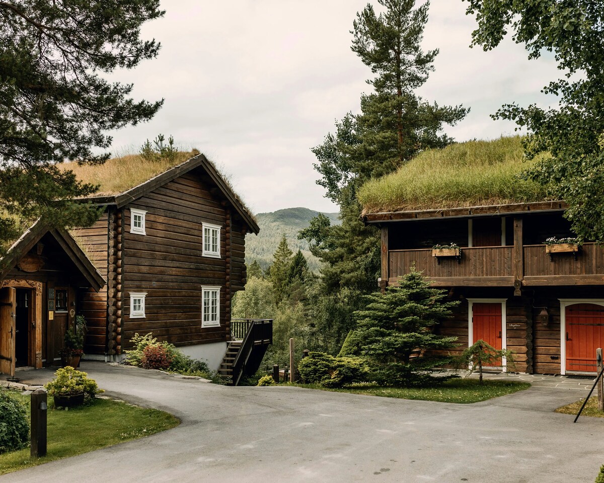 Traditional timber buildings with grass roofs at Storfjord Hotel